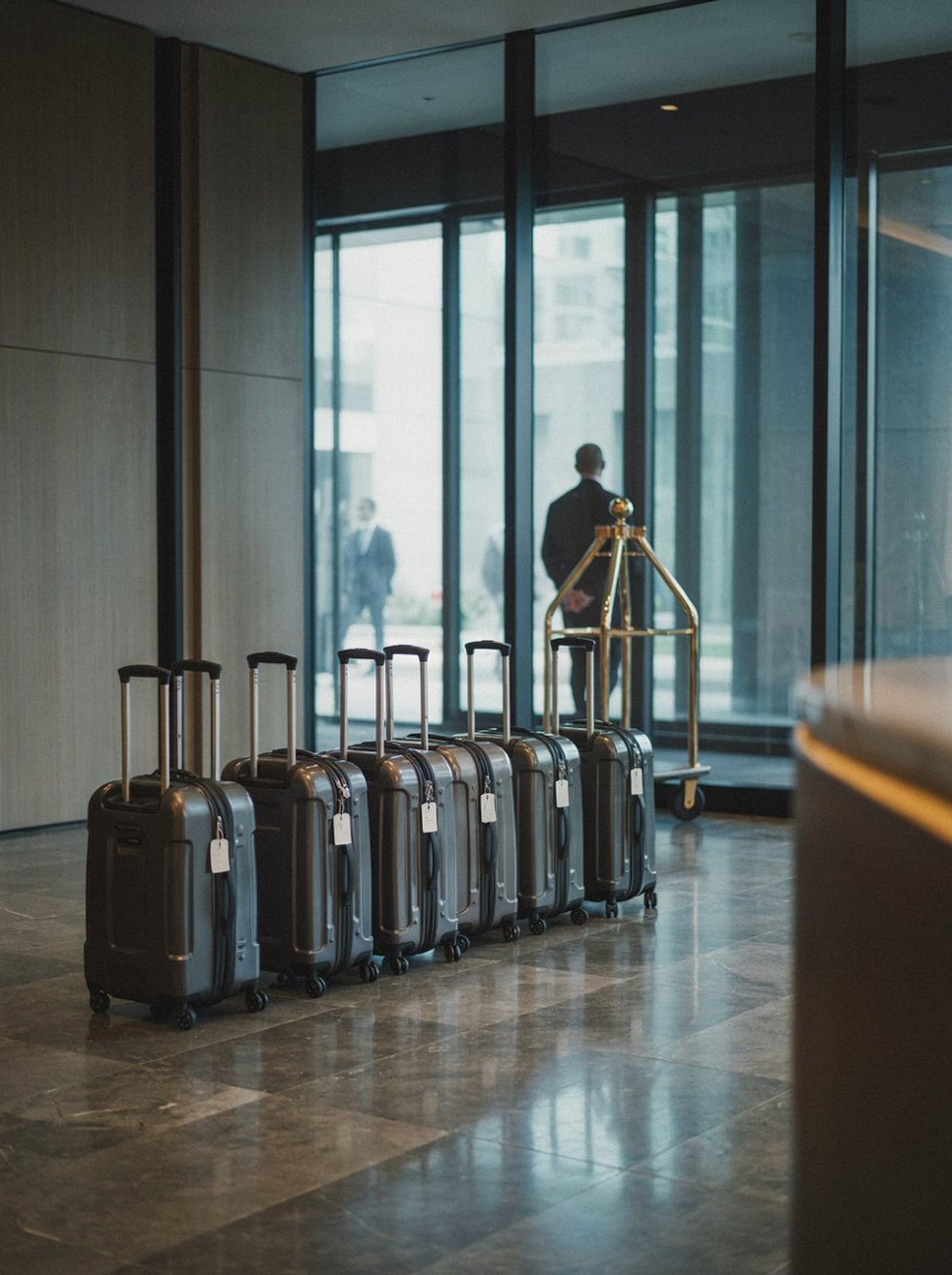 A group's luggage lined up in a hotel lobby on arrival at a congress